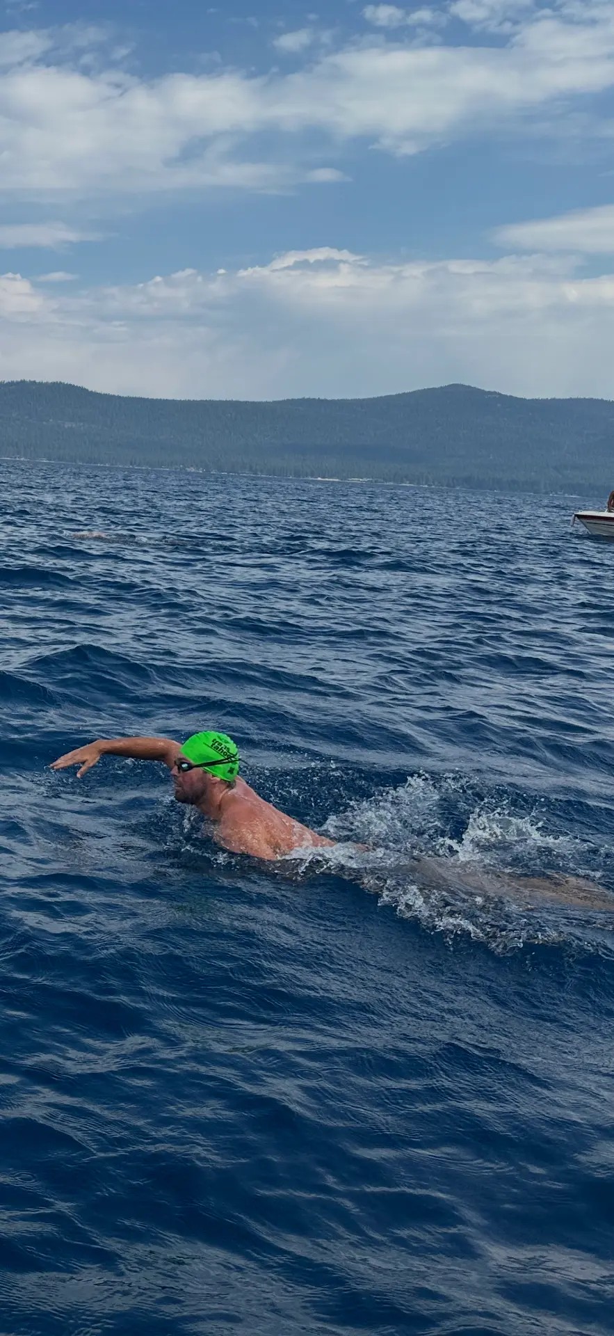 Open-water swimmer training in a mountain lake
