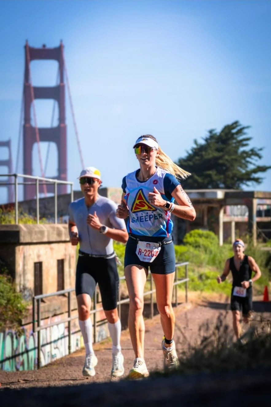 Triathlete running on a race course beside the Golden Gate Bridge