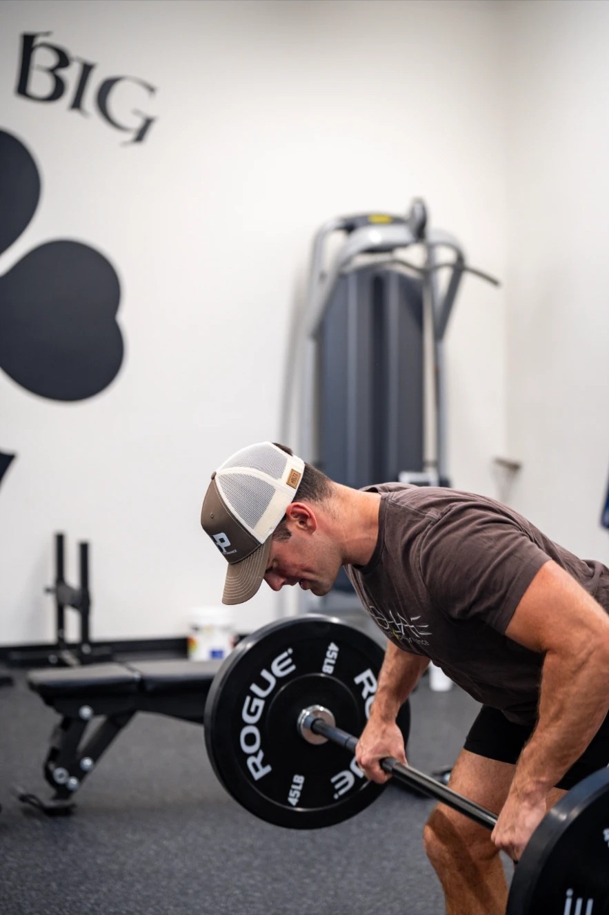 Athlete performing a barbell row in the gym